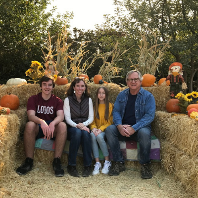 an image of erin and her family on hay bails